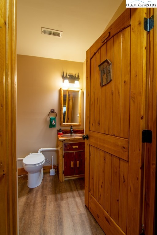 232 Bertie Circle Piney Creek, NC 28663 - Photo 47 of 50 a bathroom with a toilet a sink and a mirror
