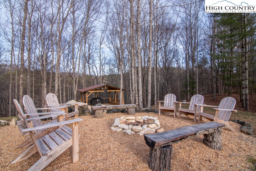 232 Bertie Circle Piney Creek, NC 28663 - Photo 9 of 50 a view of backyard with seating space and trees