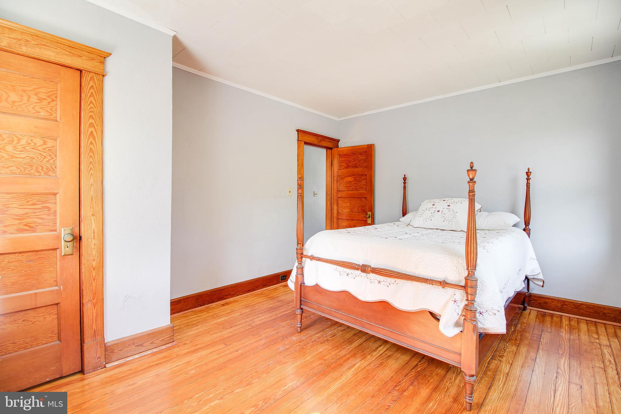 5302 Wendley Road Baltimore, MD 21229 - Photo 14 of 38 a bedroom with a bed and wooden floor
