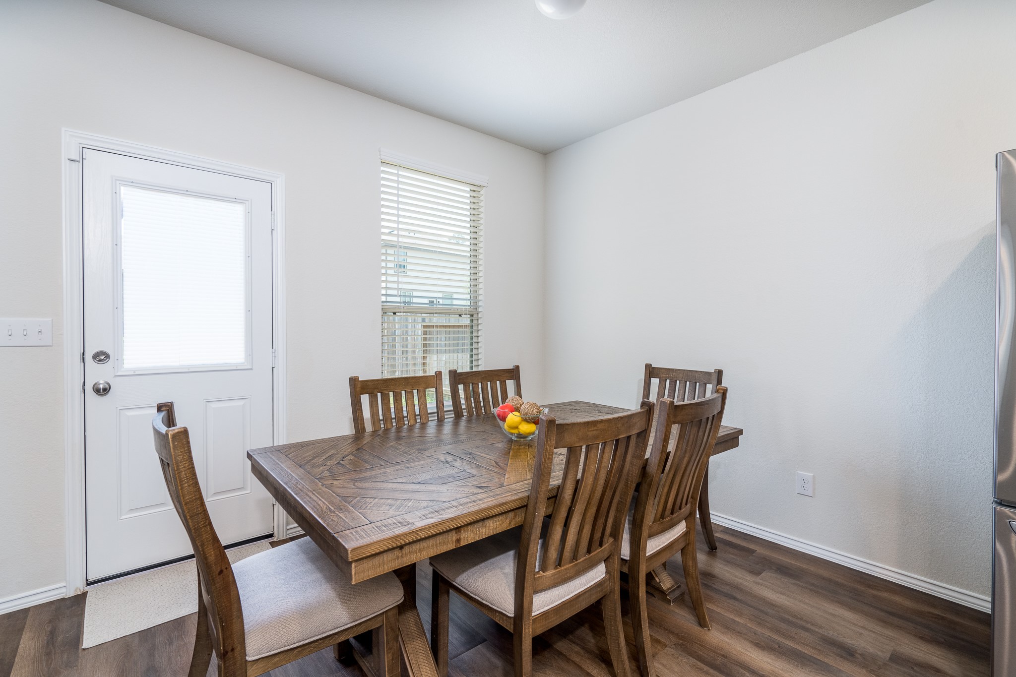 4256 Pine Still Road Conroe, TX 77304 - Photo 11 of 21 a view of a dining room with furniture and wooden floor