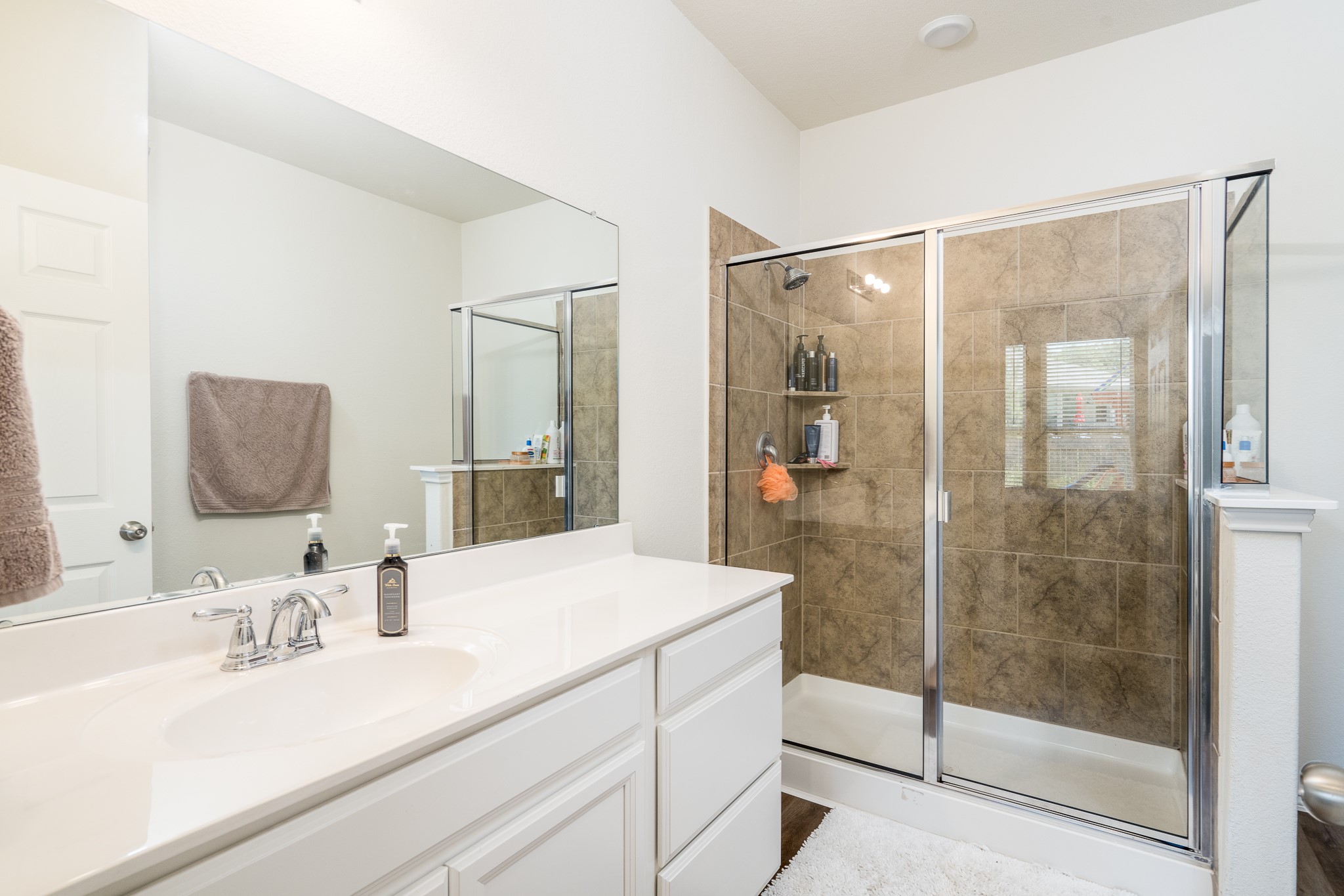 4256 Pine Still Road Conroe, TX 77304 - Photo 14 of 21 a bathroom with a sink and a mirror