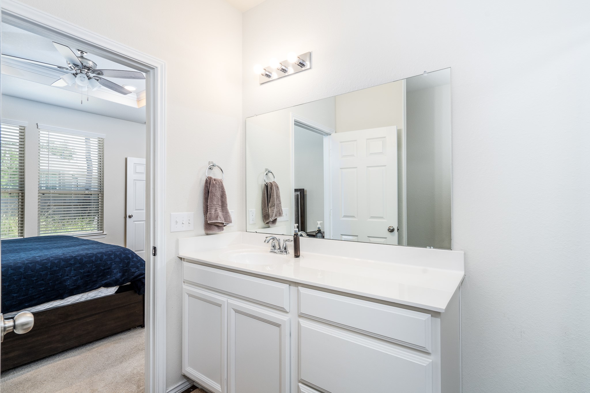 4256 Pine Still Road Conroe, TX 77304 - Photo 15 of 21 a en suite bathroom with a sink and a mirror