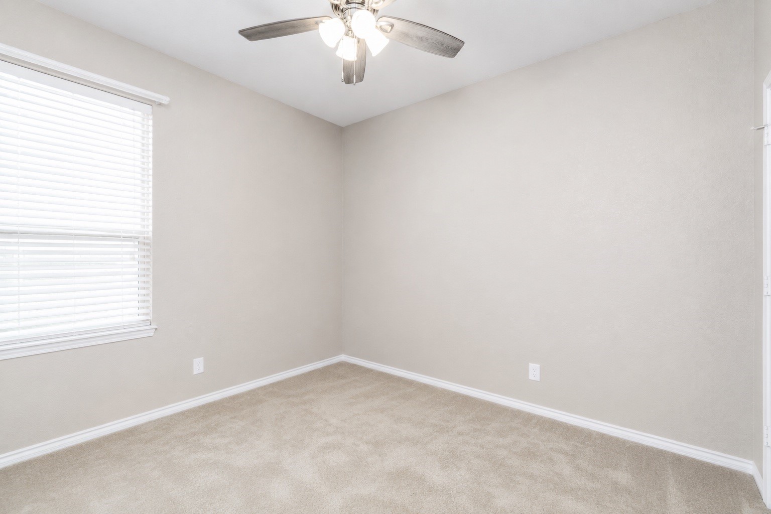 4256 Pine Still Road Conroe, TX 77304 - Photo 18 of 21 an empty room with a chandelier fan