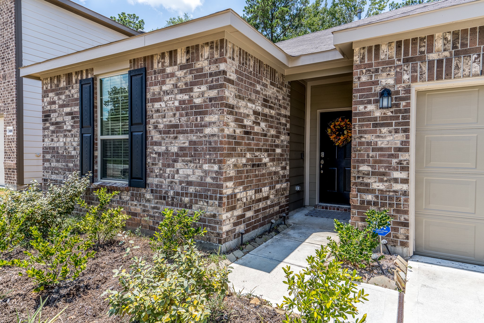 4256 Pine Still Road Conroe, TX 77304 - Photo 3 of 21 a front view of a house with a garden