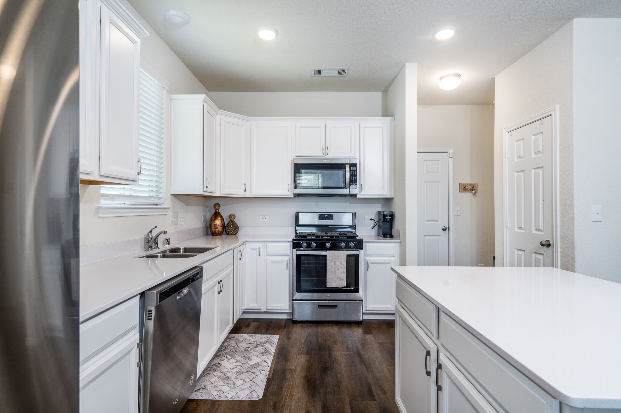 4256 Pine Still Road Conroe, TX 77304 - Photo 8 of 21 a kitchen with a sink stove and refrigerator