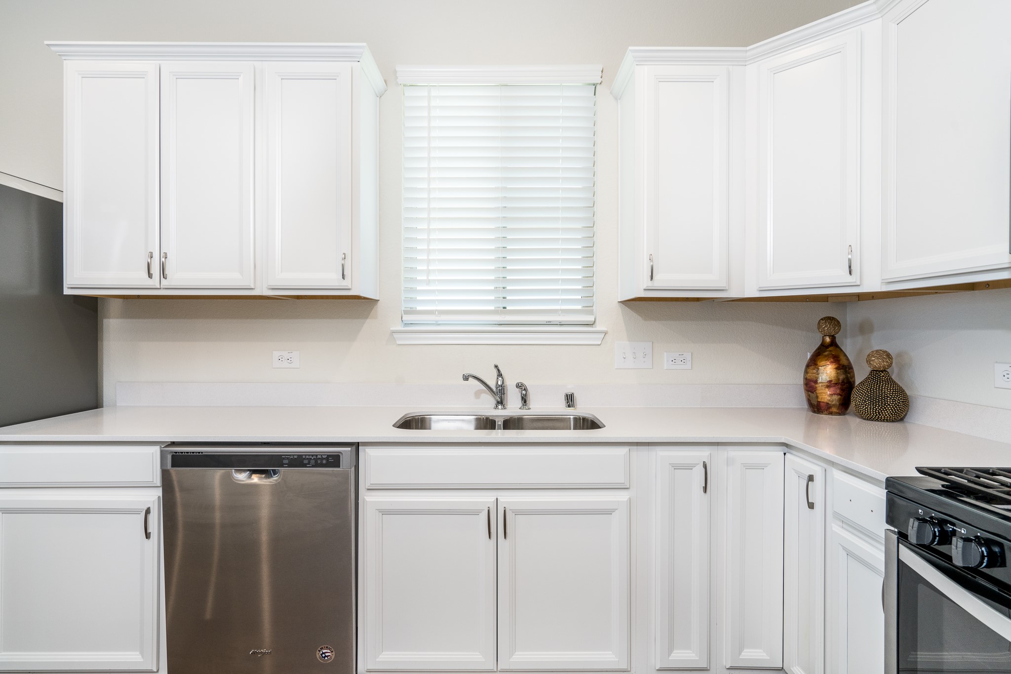 4256 Pine Still Road Conroe, TX 77304 - Photo 9 of 21 a kitchen with stainless steel appliances granite countertop a sink stove and cabinets