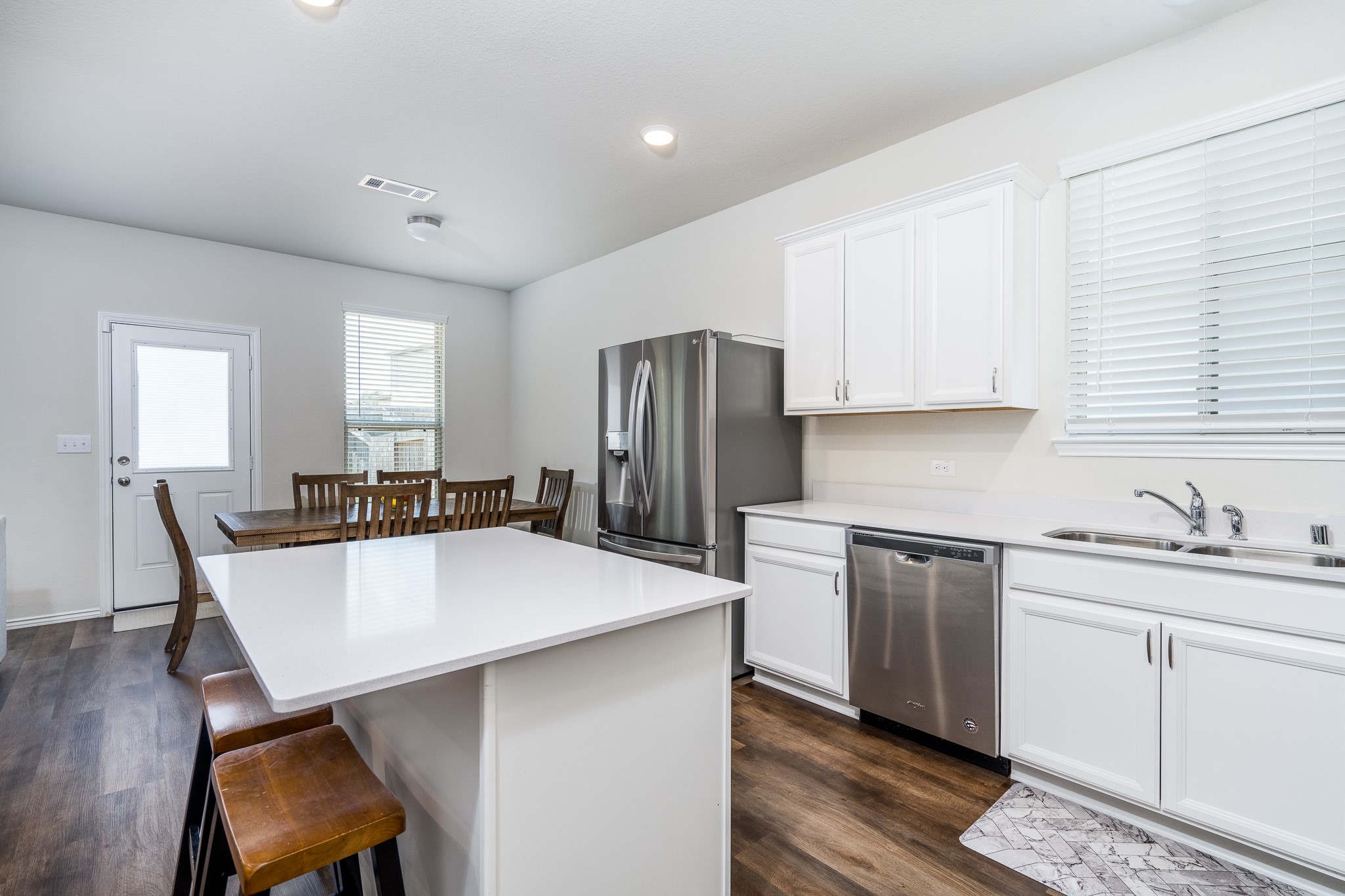 4256 Pine Still Road Conroe, TX 77304 - Photo 10 of 21 a kitchen with stainless steel appliances granite countertop a table chairs sink refrigerator and cabinets