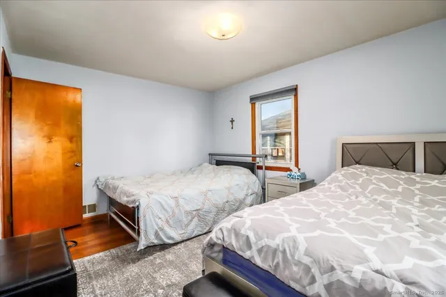 a bedroom with two beds and a window