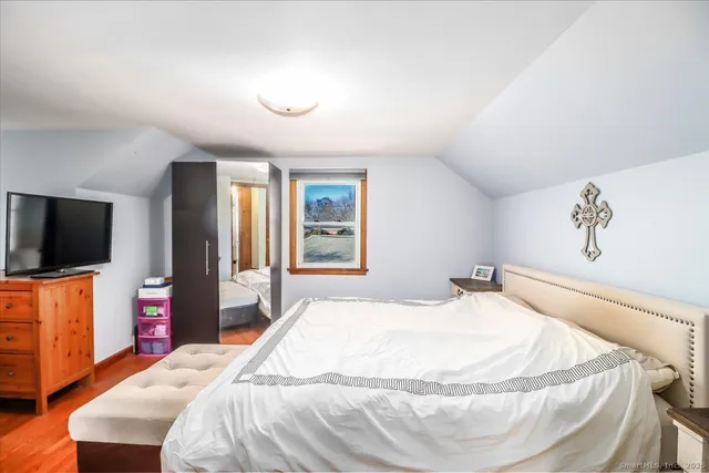 a bedroom with a bed and a flat screen tv