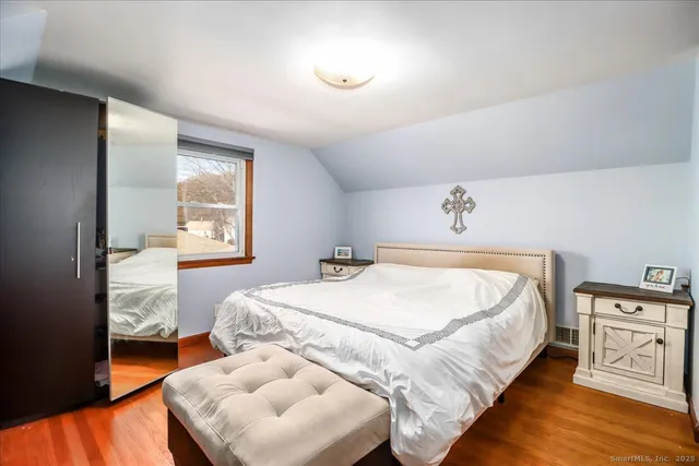 a bedroom with a bed and a night stand