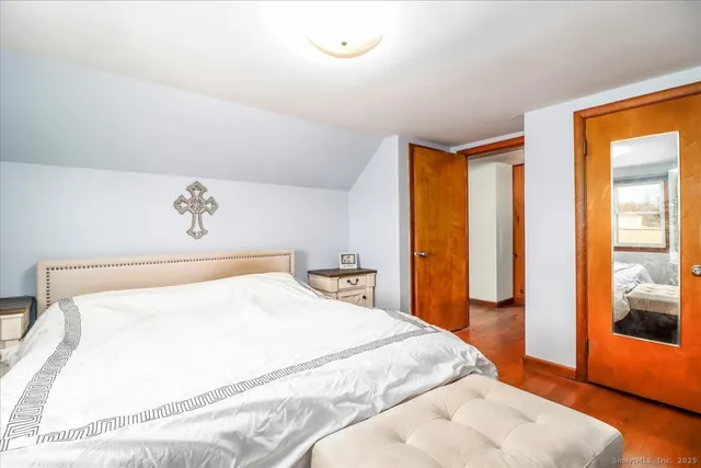 a bedroom with a large bed and a large window