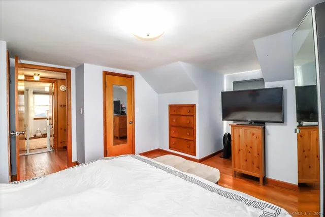 a bedroom with furniture and a flat screen tv