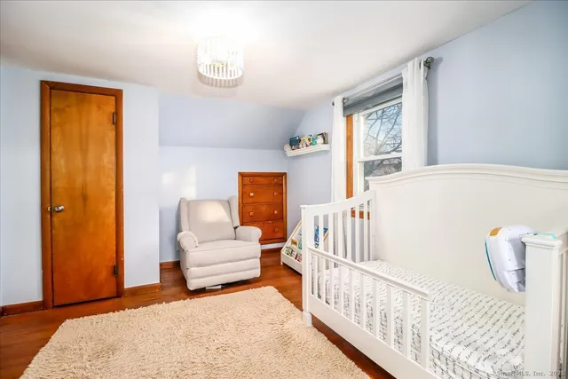 a bedroom with furniture and wooden floor