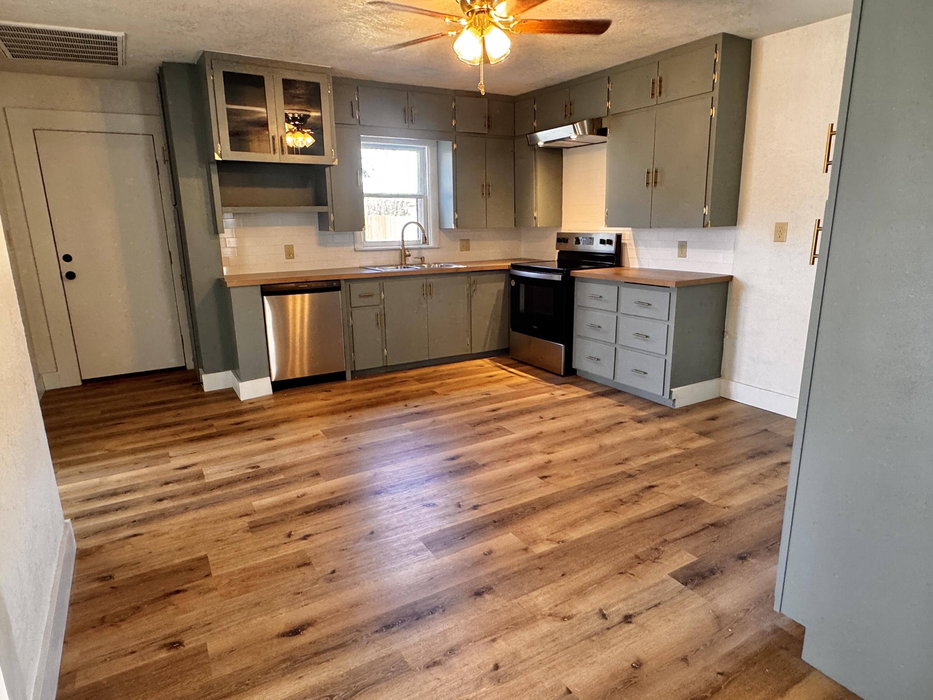 1001 Lexington Plainview, TX 79072 - Photo 11 of 31 a kitchen with stainless steel appliances granite countertop a sink cabinets and wooden floor