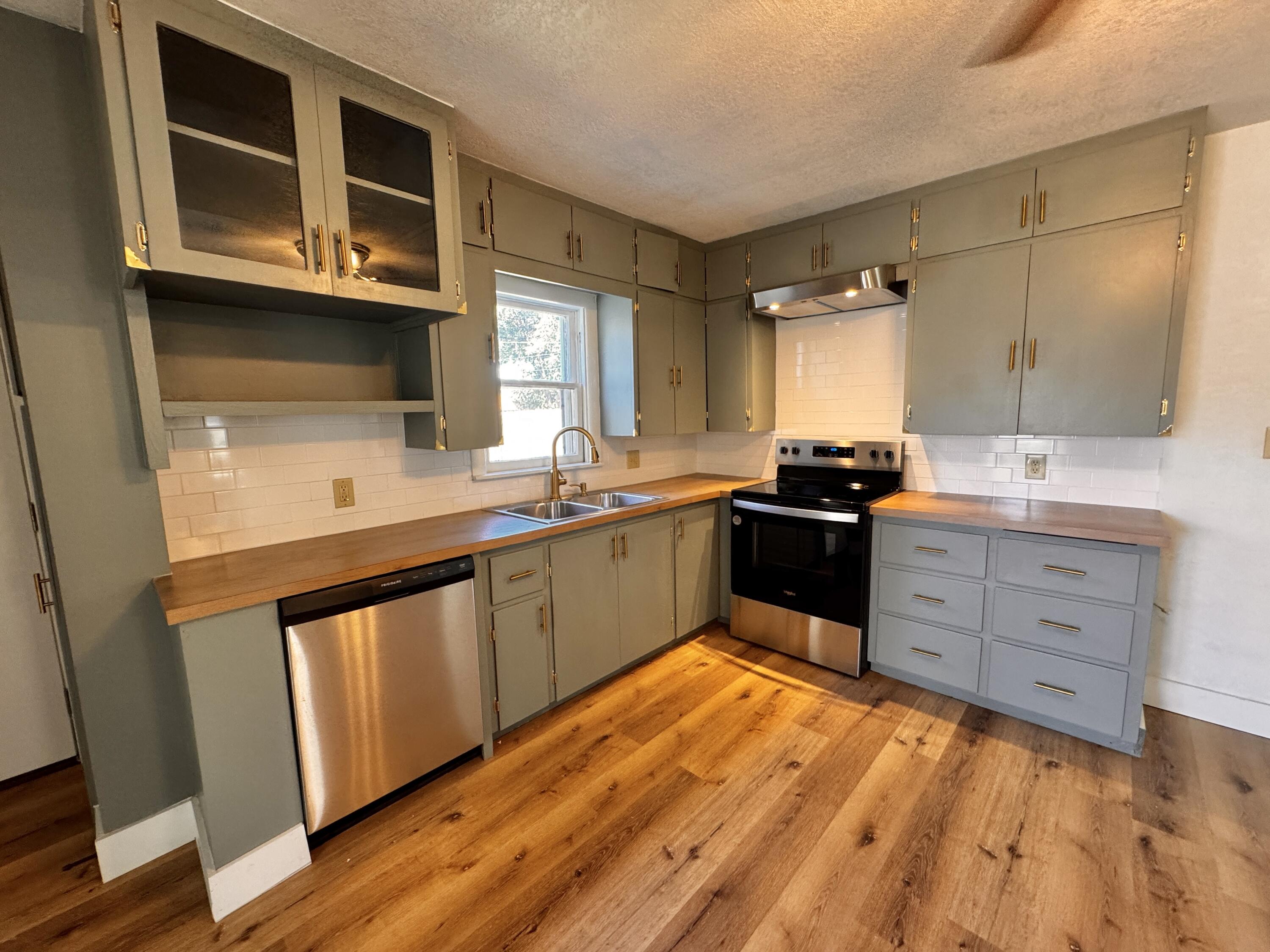 1001 Lexington Plainview, TX 79072 - Photo 12 of 31 a kitchen with stainless steel appliances kitchen island granite countertop a sink and cabinets