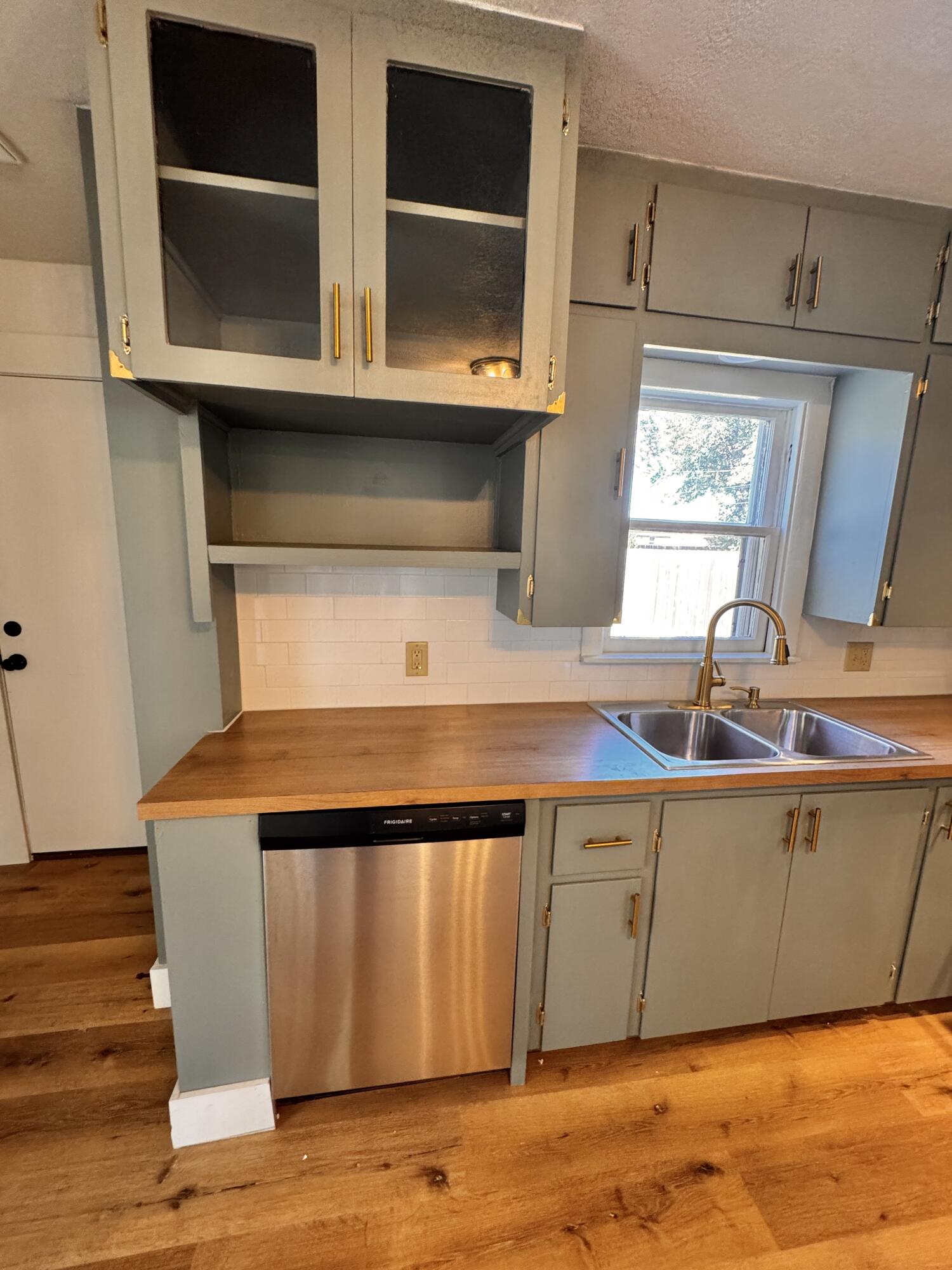 1001 Lexington Plainview, TX 79072 - Photo 14 of 31 a view of kitchen with wooden floor and cabinets