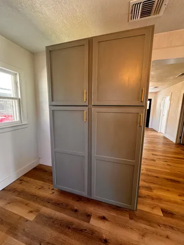 a view of wooden floor in an empty room