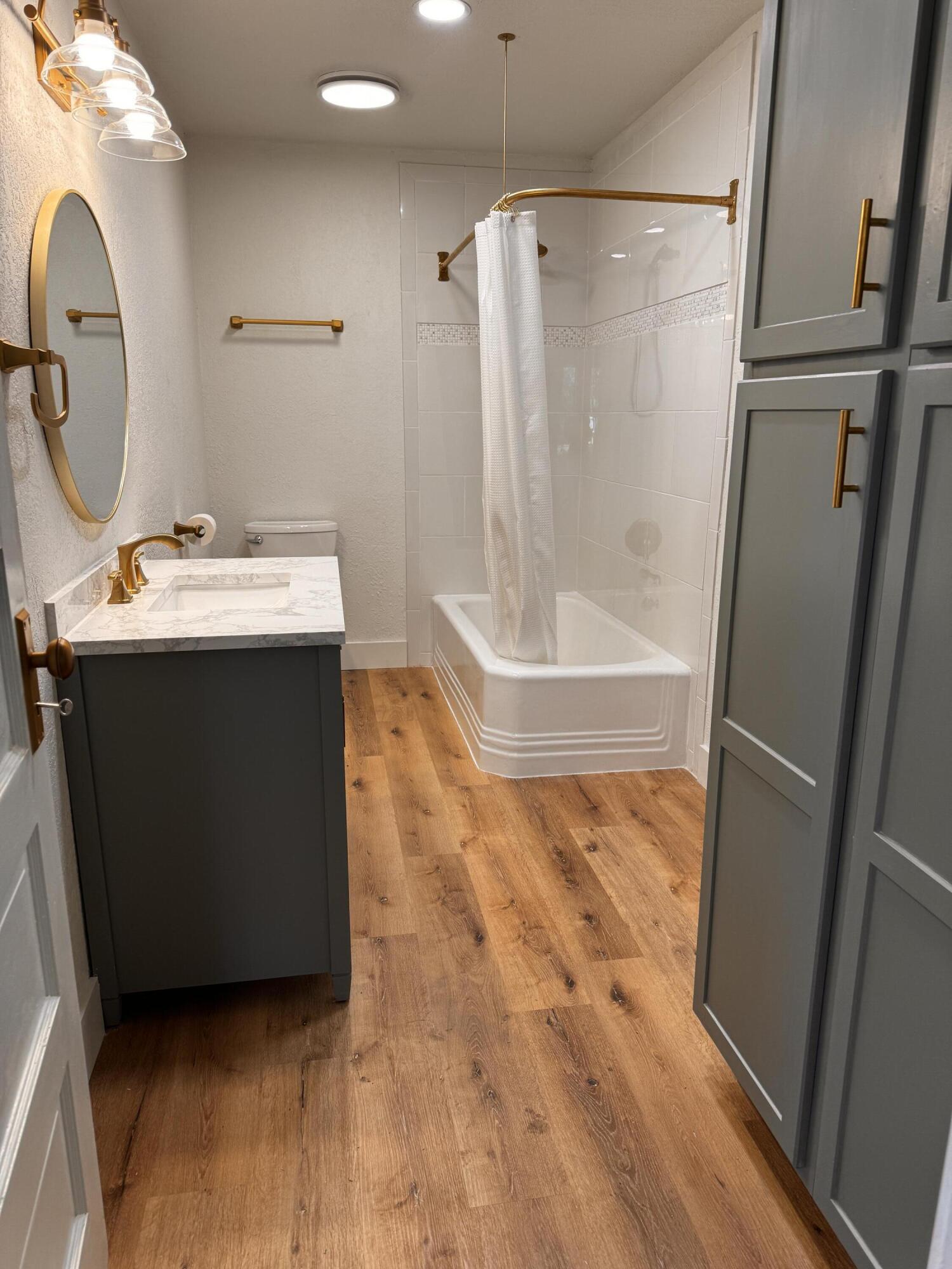 1001 Lexington Plainview, TX 79072 - Photo 19 of 31 a bathroom with a sink and mirror with bathtub