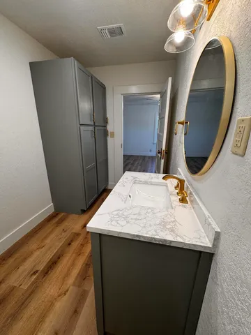 a view of bathroom with a sink and mirror