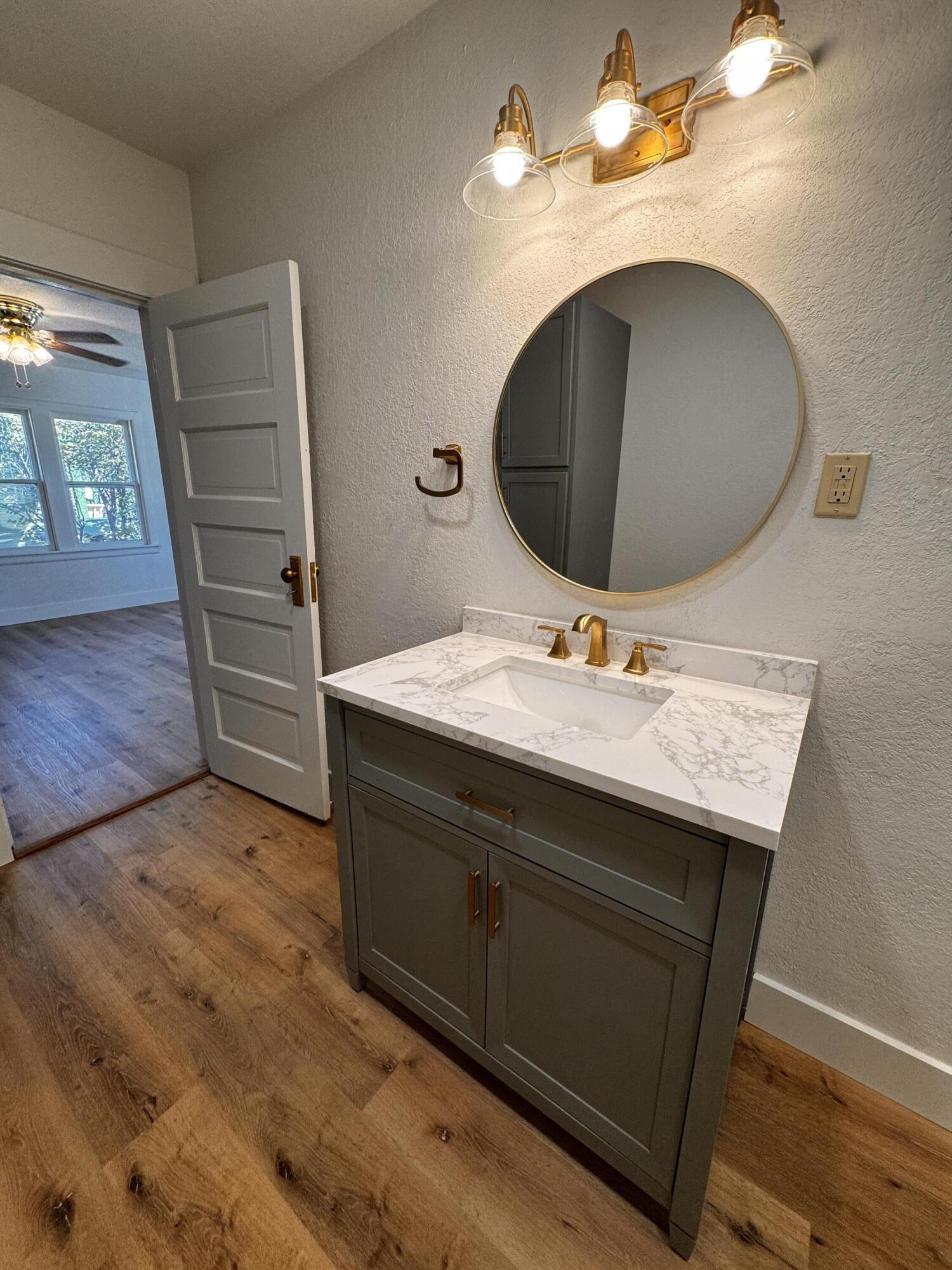 1001 Lexington Plainview, TX 79072 - Photo 22 of 31 a bathroom with a sink and a mirror