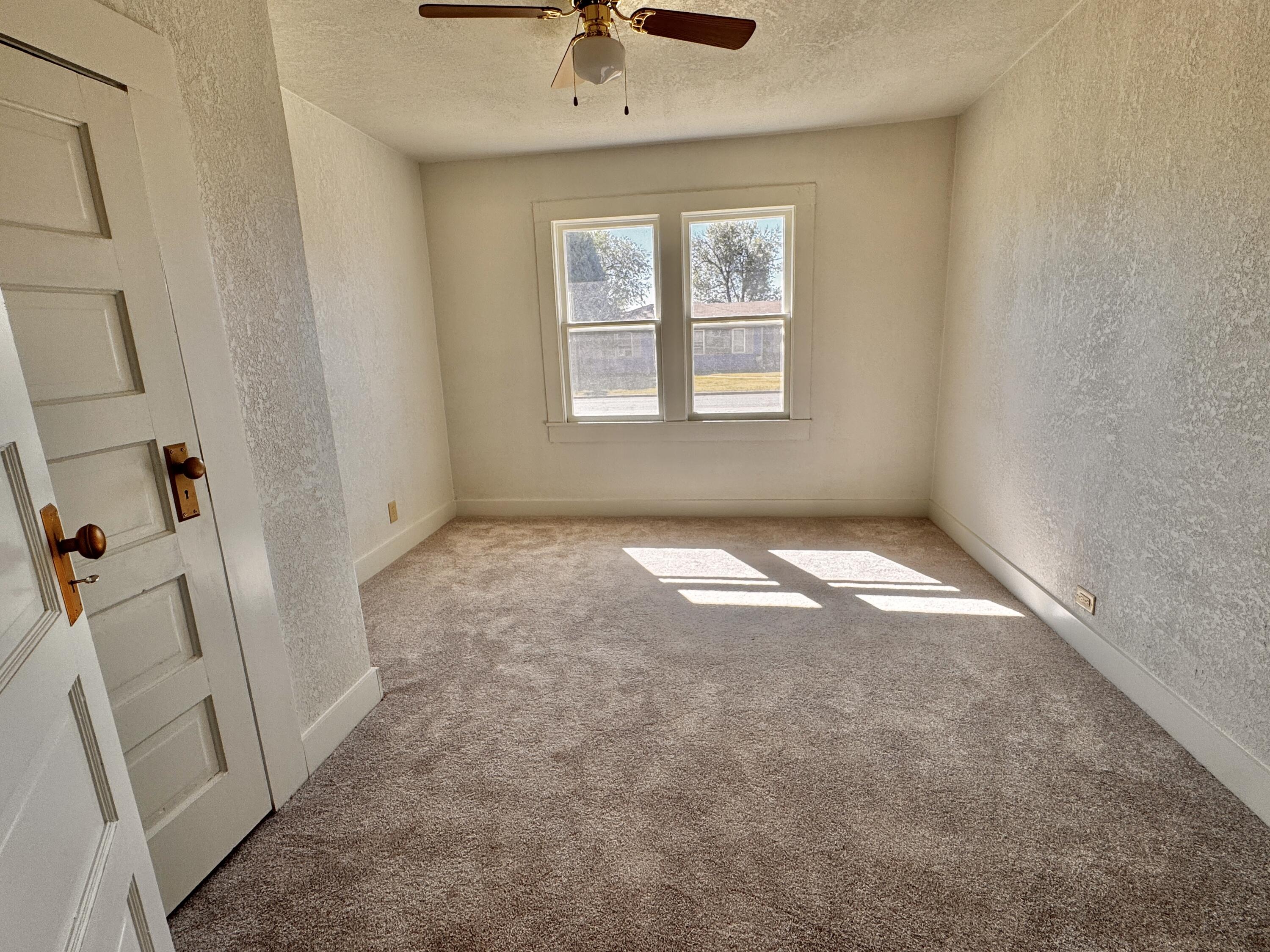 1001 Lexington Plainview, TX 79072 - Photo 25 of 31 an empty room with a window and a fan