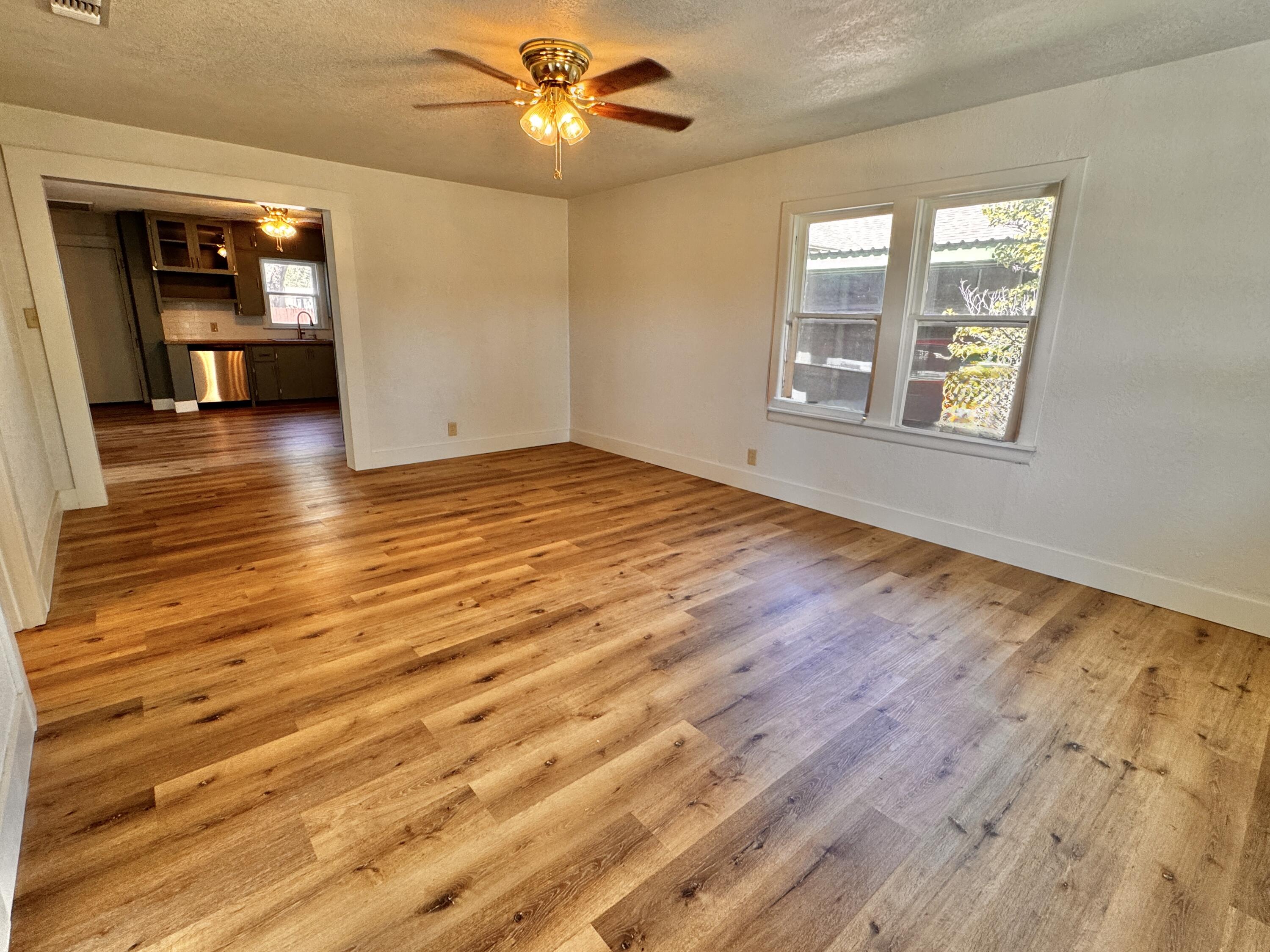 1001 Lexington Plainview, TX 79072 - Photo 9 of 31 wooden floor in an empty room with a window