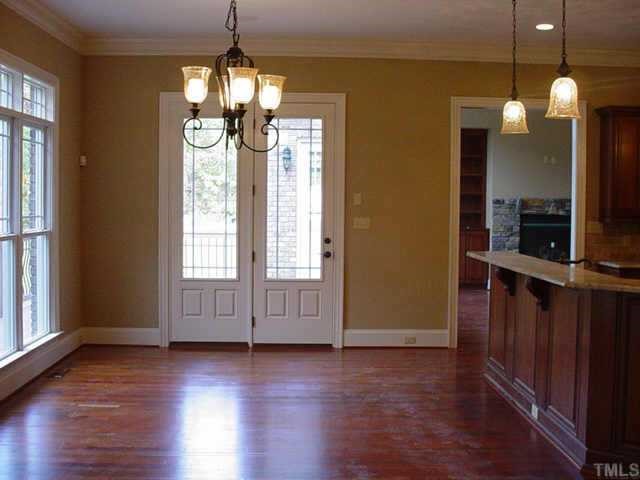 3208 Cotten Road, Unit LOT89 Raleigh, NC 27603 - Photo 11 of 12 an empty room with wooden floor and windows