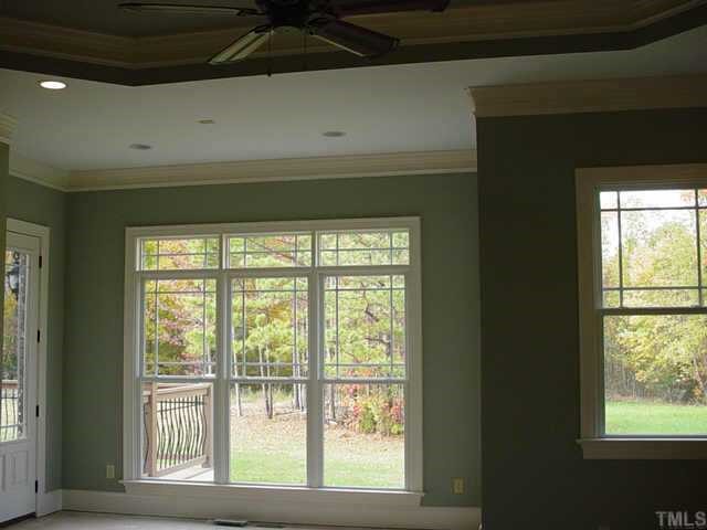3208 Cotten Road, Unit LOT89 Raleigh, NC 27603 - Photo 7 of 12 a view of an empty room with wooden floor and a window