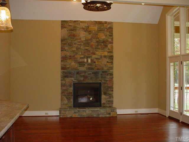 3208 Cotten Road, Unit LOT89 Raleigh, NC 27603 - Photo 10 of 12 a view of a livingroom with wooden floor and a fireplace