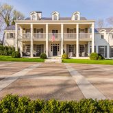 front view of a brick building next to a yard
