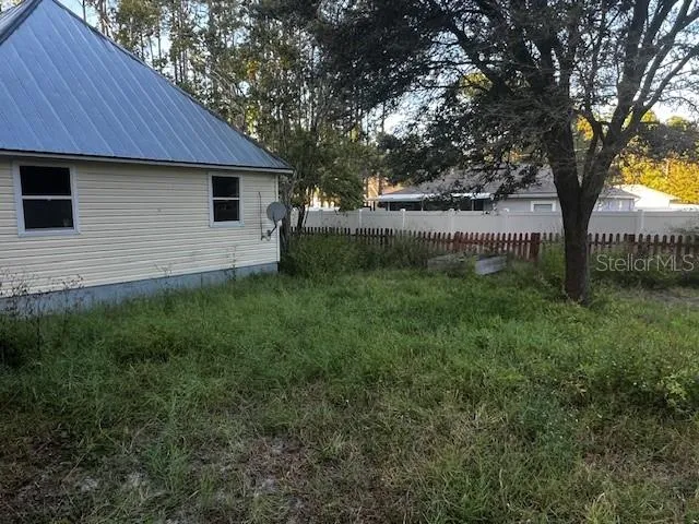 a backyard of a house with lots of green space