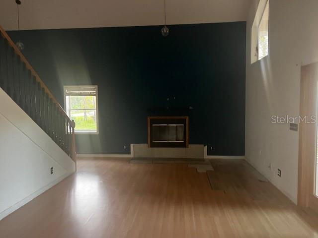 33 Seven Wonders Trail Palm Coast, FL 32164 - Photo 3 of 9 an empty room with wooden floor and windows