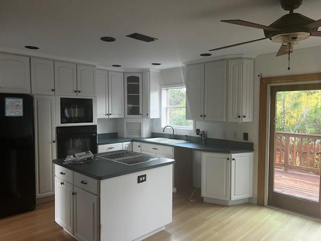 33 Seven Wonders Trail Palm Coast, FL 32164 - Photo 4 of 9 a kitchen with granite countertop a stove sink and refrigerator