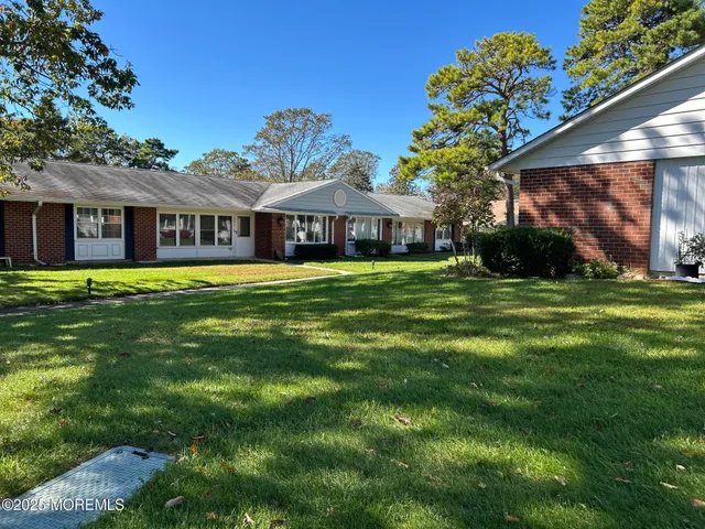 a front view of house with yard and green space