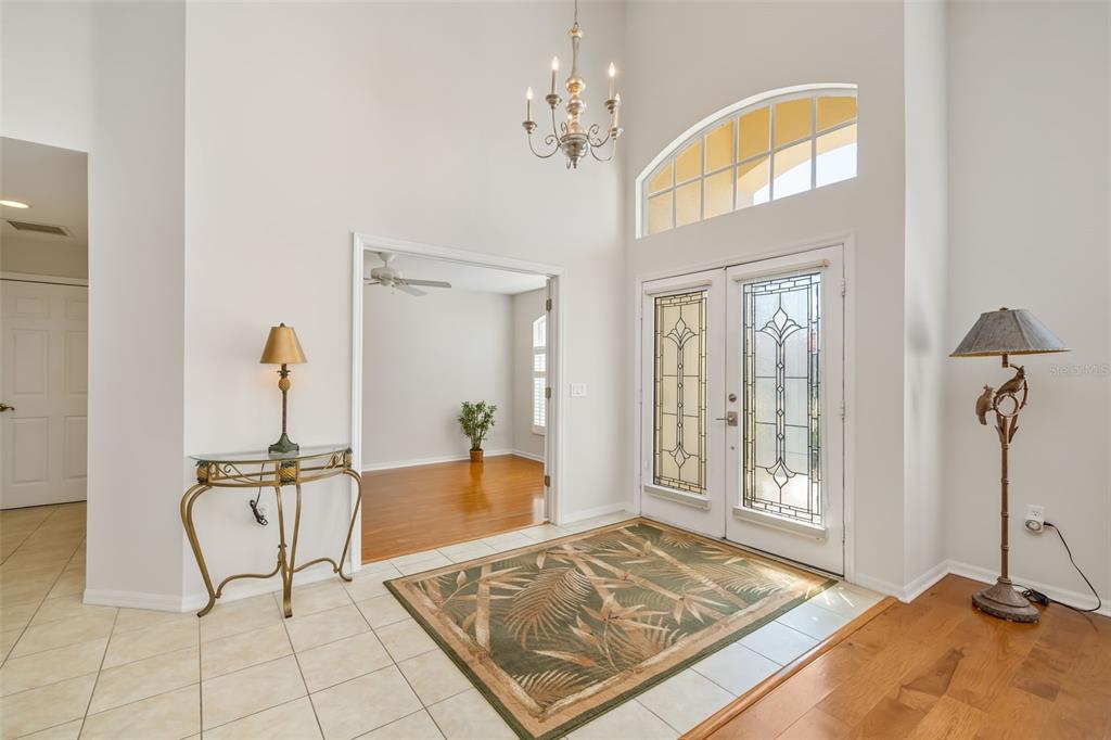 7631 Desert Inn Way Lakewood Ranch, FL 34202 - Photo 19 of 100 a view of a bedroom with a bed and glass door