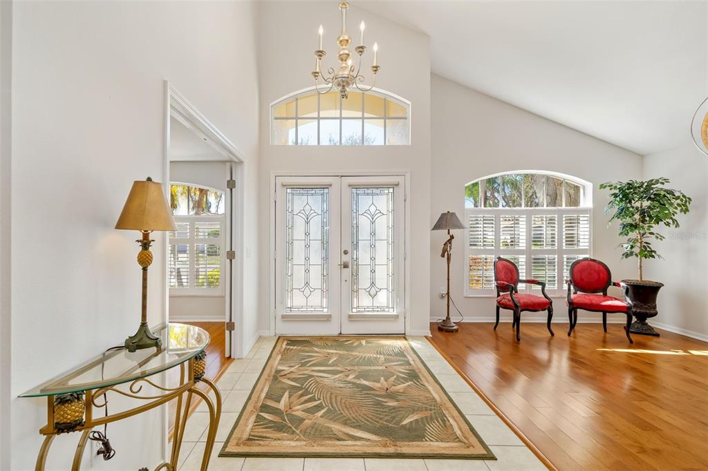 7631 Desert Inn Way Lakewood Ranch, FL 34202 - Photo 20 of 100 a living room with furniture and a chandelier