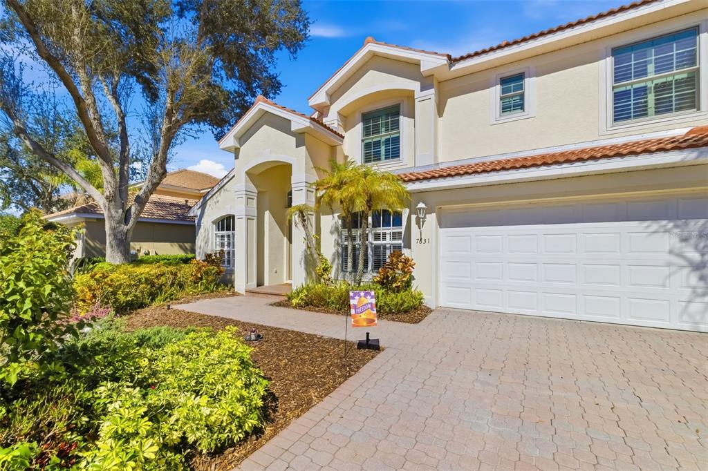 7631 Desert Inn Way Lakewood Ranch, FL 34202 - Photo 2 of 100 a front view of a house with a yard