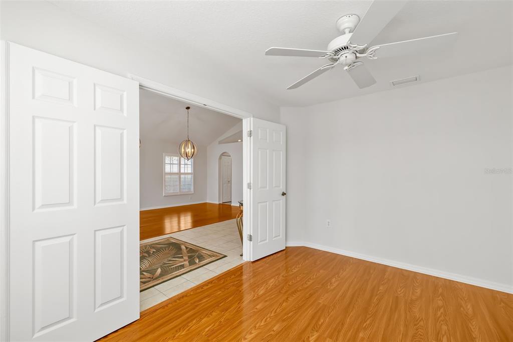 7631 Desert Inn Way Lakewood Ranch, FL 34202 - Photo 26 of 100 a view of an empty room with window and wooden floor