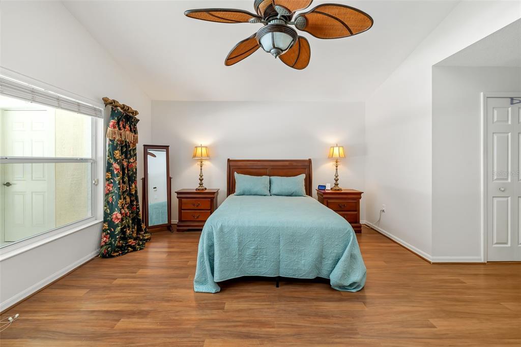 7631 Desert Inn Way Lakewood Ranch, FL 34202 - Photo 40 of 100 a bedroom with a bed and wooden floor
