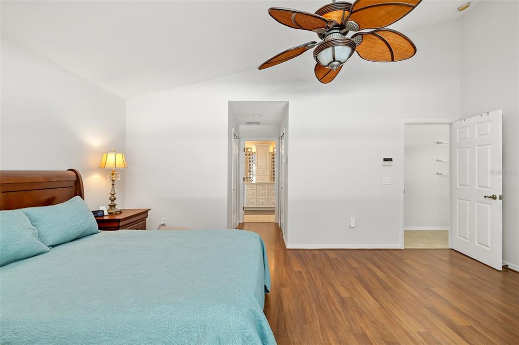 7631 Desert Inn Way Lakewood Ranch, FL 34202 - Photo 41 of 100 a bedroom with a bed and wooden floor