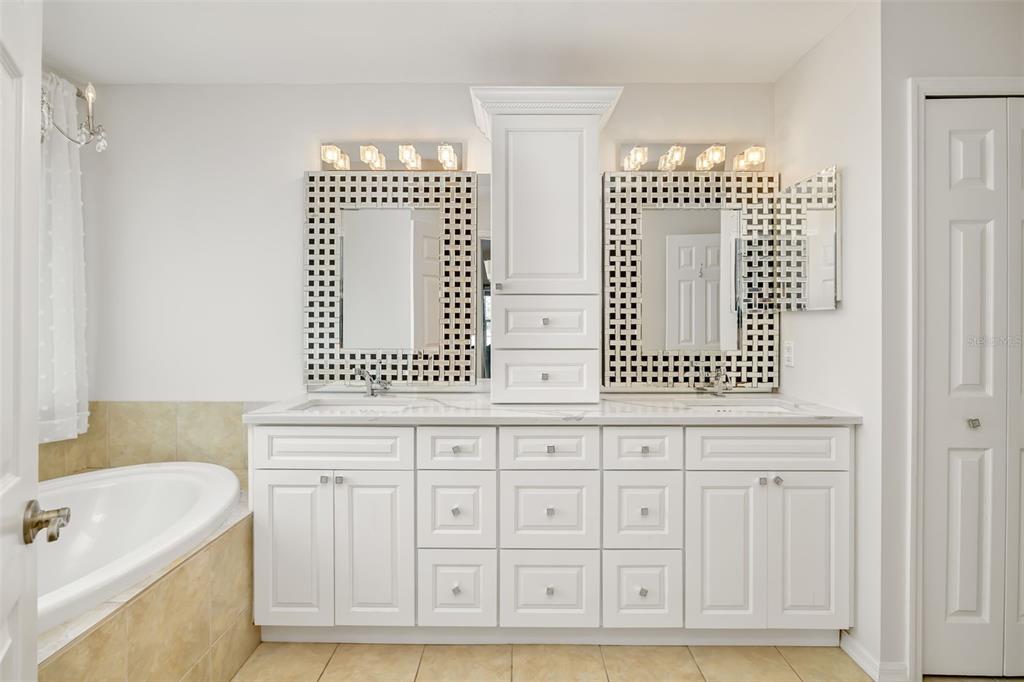 7631 Desert Inn Way Lakewood Ranch, FL 34202 - Photo 43 of 100 a bathroom with a sink a mirror and a bathtub