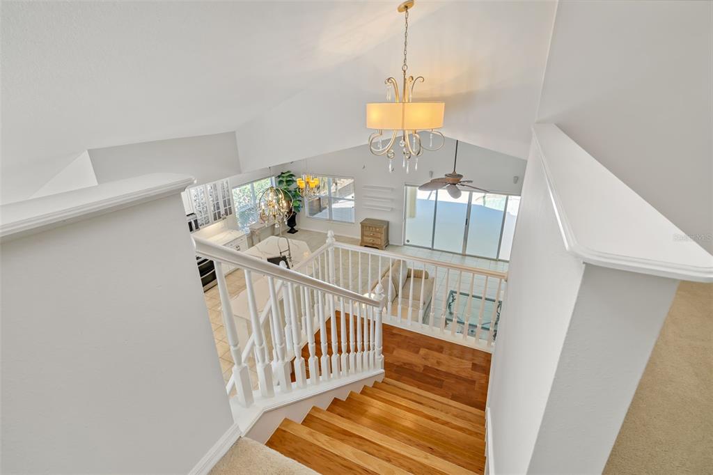 7631 Desert Inn Way Lakewood Ranch, FL 34202 - Photo 47 of 100 a view of an entryway wooden floor and chandelier