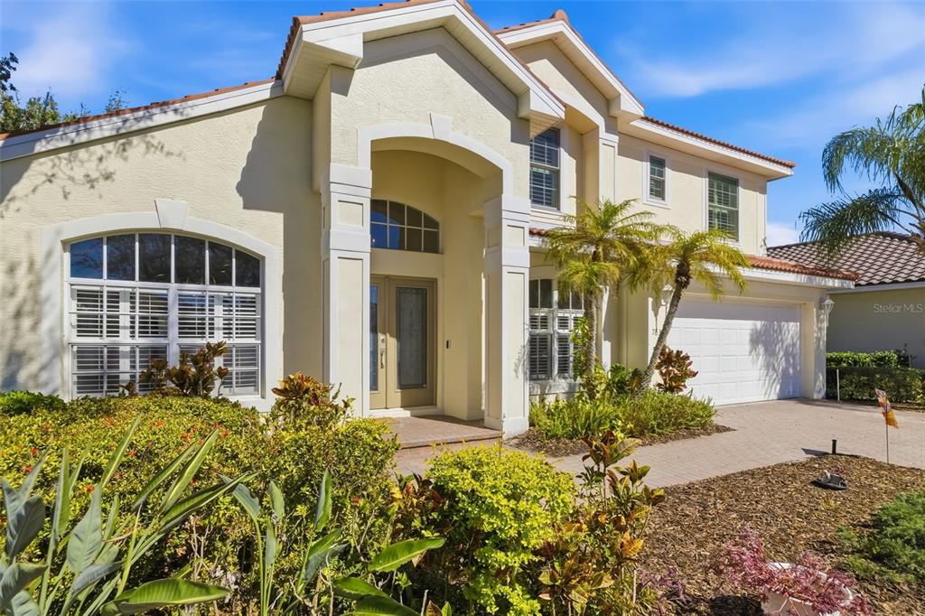 7631 Desert Inn Way Lakewood Ranch, FL 34202 - Photo 5 of 100 a front view of a house with a yard