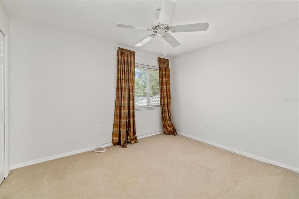 7631 Desert Inn Way Lakewood Ranch, FL 34202 - Photo 54 of 100 an empty room with a ceiling fan and window
