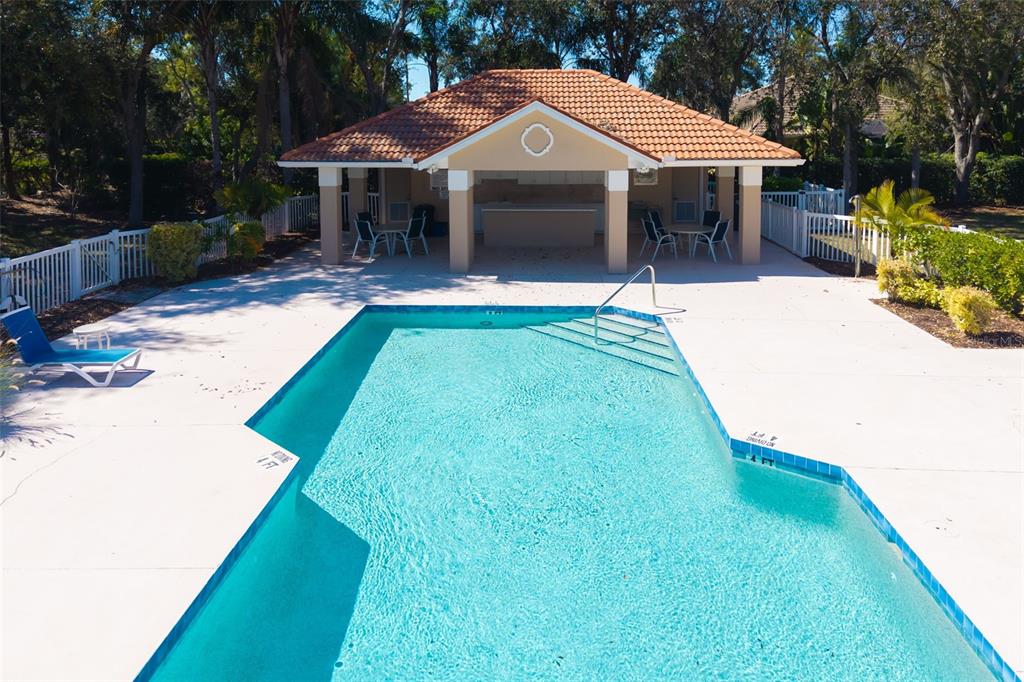 7631 Desert Inn Way Lakewood Ranch, FL 34202 - Photo 69 of 100 a view of a white house with a yard patio and a small yard