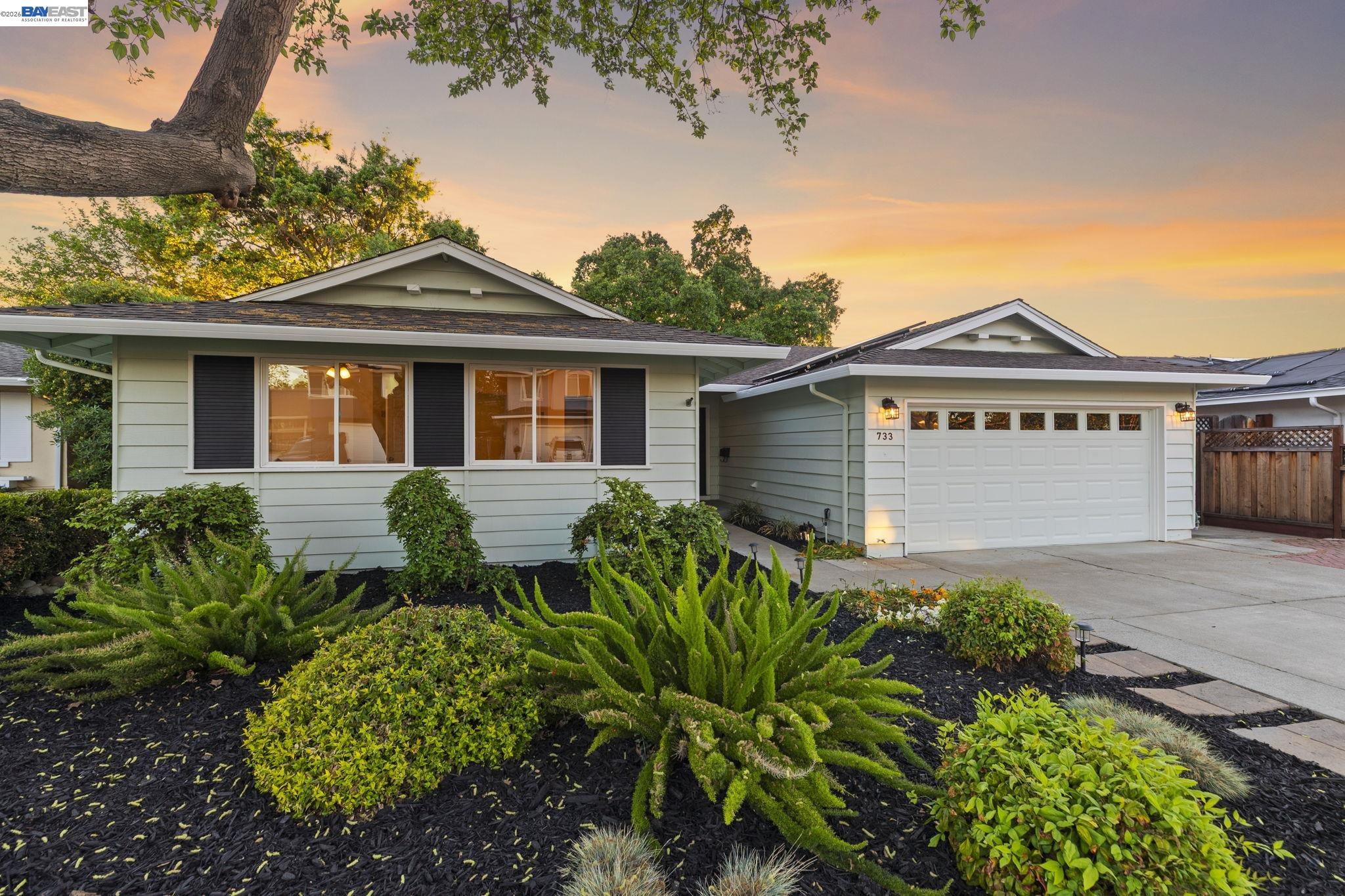 a front view of a house with a garden
