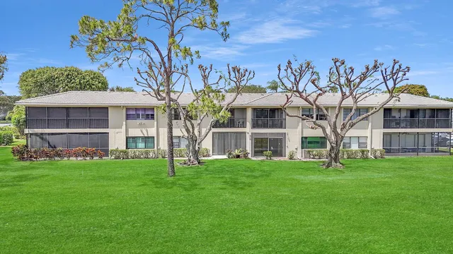 a front view of a building with a garden