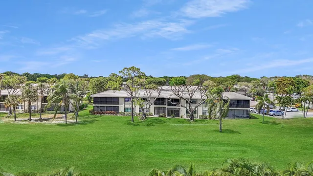 a view of a big yard with a house in the background
