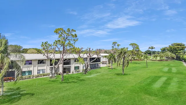 a view of a big yard with a building in the background