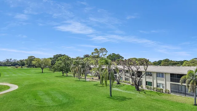 a view of a garden with a house in the background